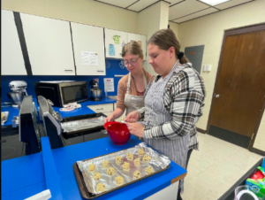 Two students making cookies