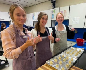 Three students making cookies